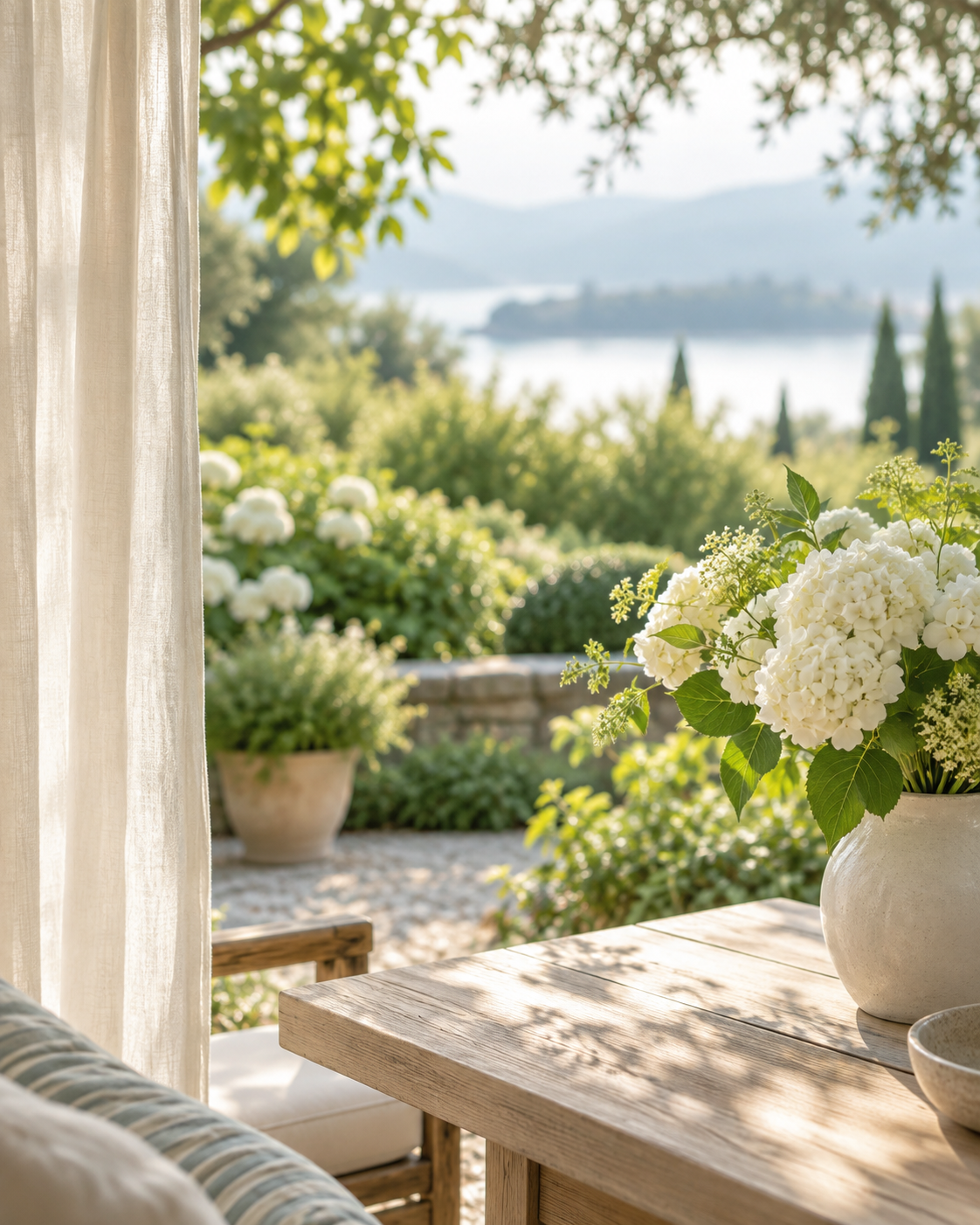 Soft morning light on a peaceful garden and a vase of white flowers